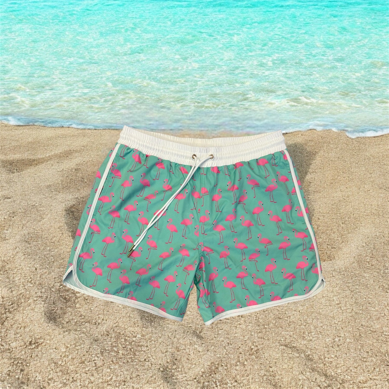 Boys swim shorts with fun summer print, displayed on a beach background